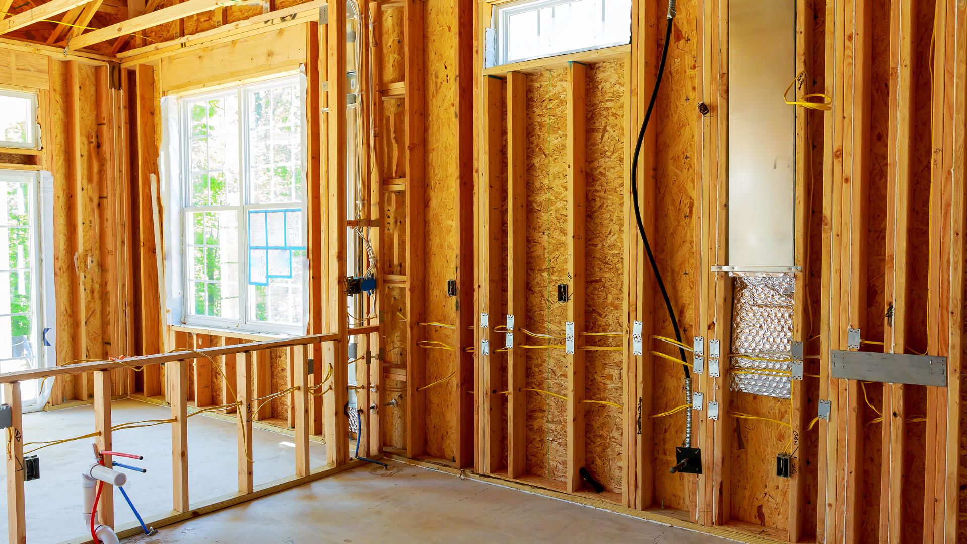 A house being built with wooden framing and a scaffolding system